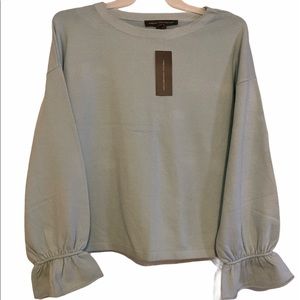 Woman’s light blue sweater.